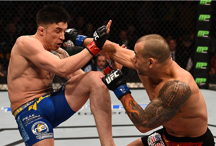 BOSTON, MA - JANUARY 18: (R-L) Gleison Tibau punches Norman Parke in their lightweight fight during the UFC Fight Night event at the TD Garden on January 18, 2015 in Boston, Massachusetts. (Photo by Jeff Bottari/Zuffa LLC/Zuffa LLC via Getty Images)