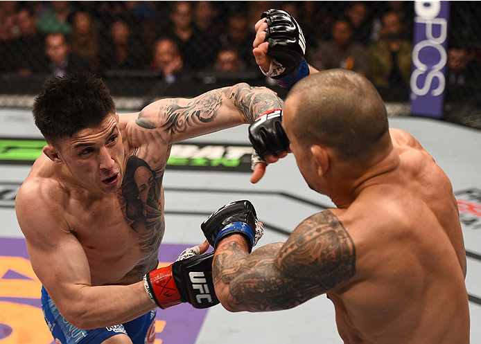 BOSTON, MA - JANUARY 18: (L-R) Norman Parke punches Gleison Tibau in their lightweight fight during the UFC Fight Night event at the TD Garden on January 18, 2015 in Boston, Massachusetts. (Photo by Jeff Bottari/Zuffa LLC/Zuffa LLC via Getty Images)