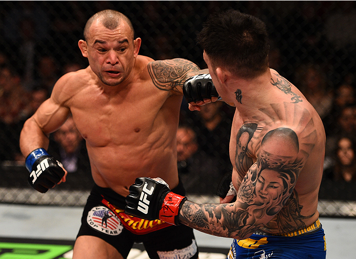 BOSTON, MA - JANUARY 18: (L-R) Gleison Tibau punches Norman Parke in their lightweight fight during the UFC Fight Night event at the TD Garden on January 18, 2015 in Boston, Massachusetts. (Photo by Jeff Bottari/Zuffa LLC/Zuffa LLC via Getty Images)