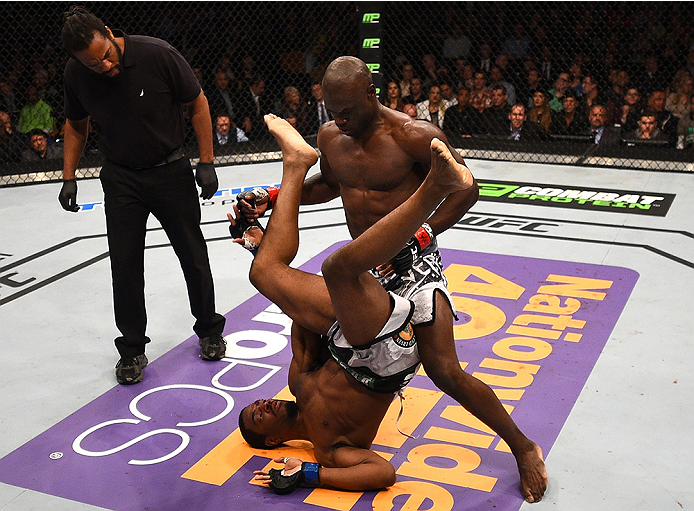 BOSTON, MA - JANUARY 18: Uriah Hall tackles Ron Stallings in their middleweight fight during the UFC Fight Night event at the TD Garden on January 18, 2015 in Boston, Massachusetts. (Photo by Jeff Bottari/Zuffa LLC/Zuffa LLC via Getty Images)