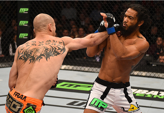 BOSTON, MA - JANUARY 18: (L-R) Donald Cerrone punches Benson Henderson in their lightweight fight during the UFC Fight Night event at the TD Garden on January 18, 2015 in Boston, Massachusetts. (Photo by Jeff Bottari/Zuffa LLC/Zuffa LLC via Getty Images)