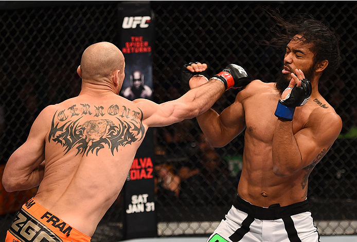 BOSTON, MA - JANUARY 18: (L-R) Donald Cerrone punches Benson Henderson in their lightweight fight during the UFC Fight Night event at the TD Garden on January 18, 2015 in Boston, Massachusetts. (Photo by Jeff Bottari/Zuffa LLC/Zuffa LLC via Getty Images)