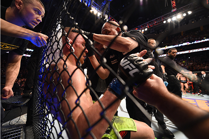 BOSTON, MA - JANUARY 18:  Dennis Siver of Germany receives treatment during a featherweight fight against Conor McGregor of Ireland during the UFC Fight Night event at the TD Garden on January 18, 2015 in Boston, Massachusetts. (Photo by Jeff Bottari/Zuff