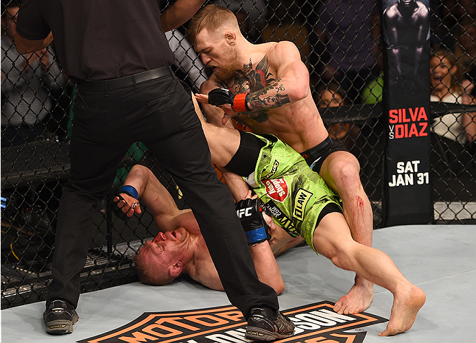 BOSTON, MA - JANUARY 18: Conor McGregor of Ireland tackles Dennis Siver of Germany in their featherweight fight during the UFC Fight Night event at the TD Garden on January 18, 2015 in Boston, Massachusetts. (Photo by Jeff Bottari/Zuffa LLC/Zuffa LLC via