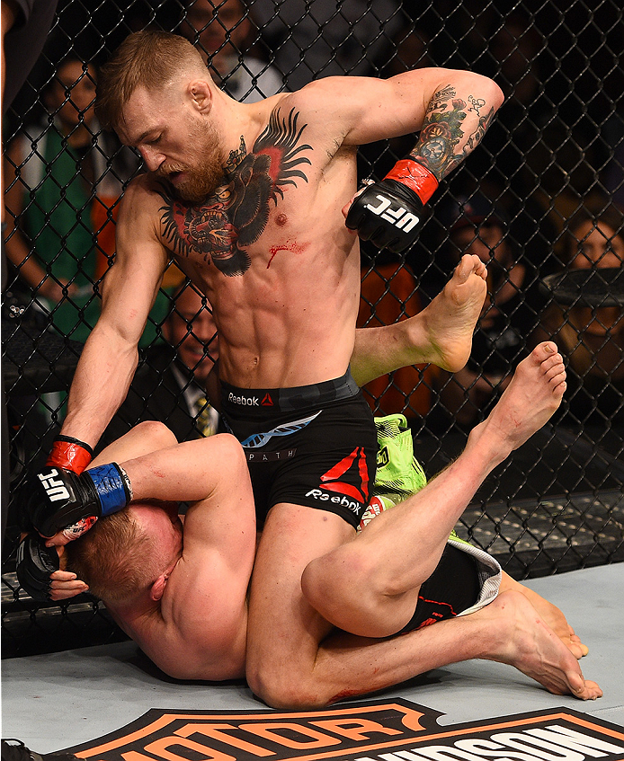 BOSTON, MA - JANUARY 18: Conor McGregor of Ireland punches Dennis Siver of Germany in their featherweight fight during the UFC Fight Night event at the TD Garden on January 18, 2015 in Boston, Massachusetts. (Photo by Jeff Bottari/Zuffa LLC/Zuffa LLC via