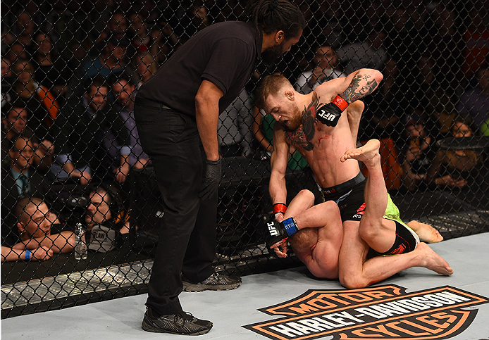BOSTON, MA - JANUARY 18: Conor McGregor of Ireland punches Dennis Siver of Germany in their featherweight fight during the UFC Fight Night event at the TD Garden on January 18, 2015 in Boston, Massachusetts. (Photo by Jeff Bottari/Zuffa LLC/Zuffa LLC via