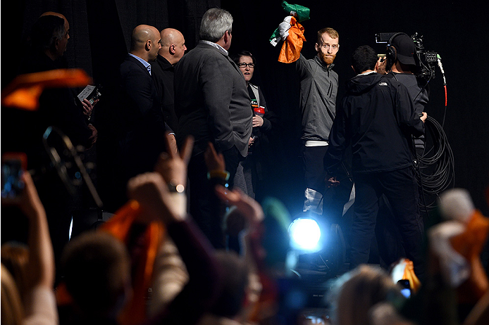 BOSTON, MA - JANUARY 17: Paddy Holohan of Ireland interacts with the crowd holding an Irish flag as he walks on stage during the UFC Fight Night Boston weigh-in event at the Orpheum Theatre on January 17, 2015 in Boston, Massachusetts. (Photo by Jeff Bot