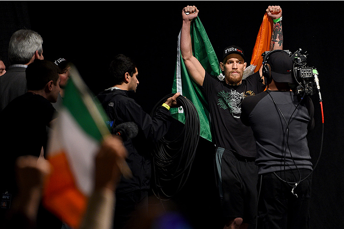 BOSTON, MA - JANUARY 17: Conor 'The Notorious' McGregor of Ireland walks on stage holding an Irish flag during the UFC Fight Night Boston weigh-in event at the Orpheum Theatre on January 17, 2015 in Boston, Massachusetts. (Photo by Jeff Bottari/Zuffa LLC
