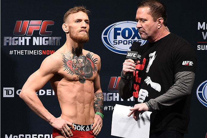 BOSTON, MA - JANUARY 17:  Conor 'The Notorious' McGregor of Ireland (L) speaks with UFC commentator Mike Goldberg during the UFC Fight Night Boston weigh-in event at the Orpheum Theatre on January 17, 2015 in Boston, Massachusetts. (Photo by Jeff Bottari/