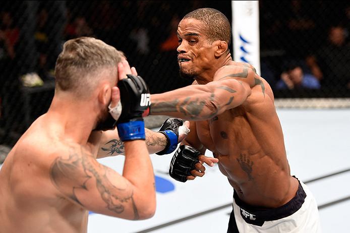 BRISBANE, AUSTRALIA - MARCH 20:   (R-L) Alan Patrick of Brazil punches Damien Brown of Australia in their lightweight bout during the UFC Fight Night event at the Brisbane Entertainment Centre on March 20, 2016 in Brisbane, Australia. (Photo by Josh Hedge