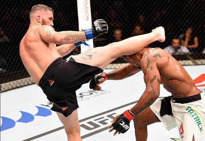 BRISBANE, AUSTRALIA - MARCH 20: (L-R) Damien Brown of Australia kicks Alan Patrick of Brazil in their lightweight bout during the UFC Fight Night event at the Brisbane Entertainment Centre on March 20, 2016 in Brisbane, Australia. (Photo by Josh Hedges/