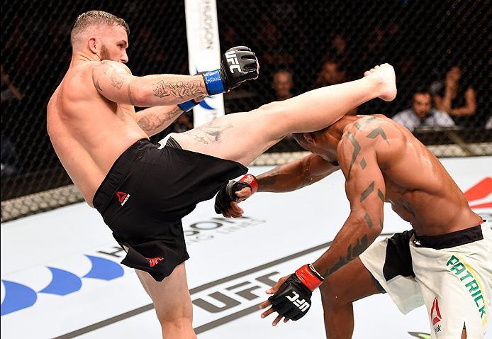 BRISBANE, AUSTRALIA - MARCH 20:   (L-R) Damien Brown of Australia kicks Alan Patrick of Brazil in their lightweight bout during the UFC Fight Night event at the Brisbane Entertainment Centre on March 20, 2016 in Brisbane, Australia. (Photo by Josh Hedges/