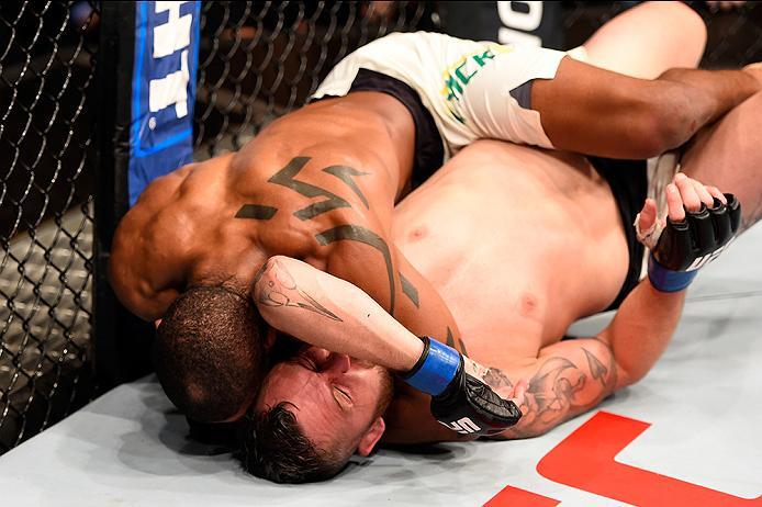 BRISBANE, AUSTRALIA - MARCH 20:   (L-R) Alan Patrick of Brazil attempts a submission against Damien Brown of Australia in their lightweight bout during the UFC Fight Night event at the Brisbane Entertainment Centre on March 20, 2016 in Brisbane, Australia