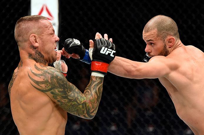 BRISBANE, AUSTRALIA - MARCH 20:   (R-L) Chad Laprise of Canada punches Ross Pearson of England in their lightweight bout during the UFC Fight Night event at the Brisbane Entertainment Centre on March 20, 2016 in Brisbane, Australia. (Photo by Josh Hedges/