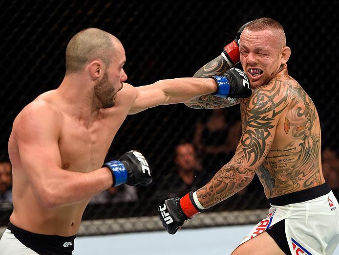 BRISBANE, AUSTRALIA - MARCH 20:   (L-R) Chad Laprise of Canada punches Ross Pearson of England in their lightweight bout during the UFC Fight Night event at the Brisbane Entertainment Centre on March 20, 2016 in Brisbane, Australia. (Photo by Josh Hedges/