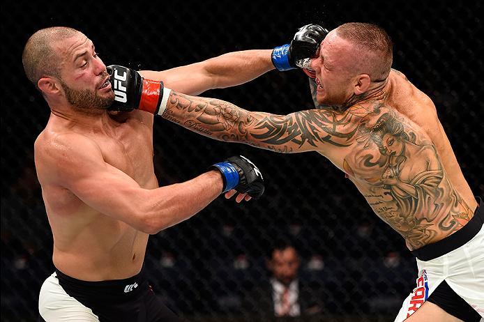 BRISBANE, AUSTRALIA - MARCH 20:   (R-L) Ross Pearson of England punches Chad Laprise of Canada in their lightweight bout during the UFC Fight Night event at the Brisbane Entertainment Centre on March 20, 2016 in Brisbane, Australia. (Photo by Josh Hedges/