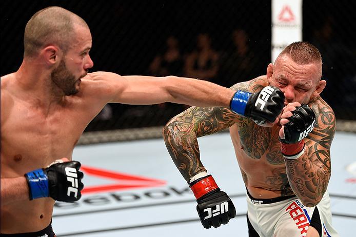 BRISBANE, AUSTRALIA - MARCH 20:   (L-R) Chad Laprise of Canada punches Ross Pearson of England in their lightweight bout during the UFC Fight Night event at the Brisbane Entertainment Centre on March 20, 2016 in Brisbane, Australia. (Photo by Josh Hedges/