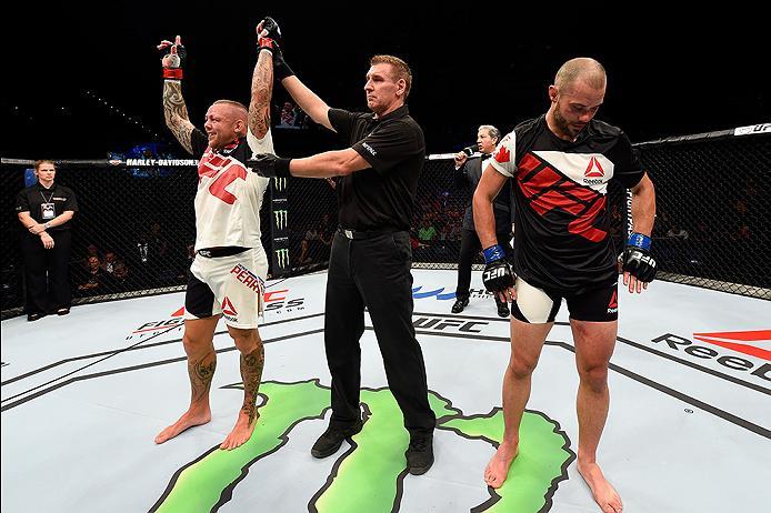 BRISBANE, AUSTRALIA - MARCH 20:   (L-R) Ross Pearson of England celebrates after defeating Chad Laprise of Canada by split decision in their lightweight bout during the UFC Fight Night event at the Brisbane Entertainment Centre on March 20, 2016 in Brisba