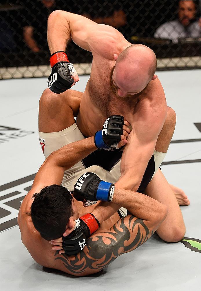 BRISBANE, AUSTRALIA - MARCH 20:  Rich Walsh of Australia (top) punches Viscardi Andrade of Brazil in their welterweight bout during the UFC Fight Night event at the Brisbane Entertainment Centre on March 20, 2016 in Brisbane, Australia. (Photo by Josh Hed