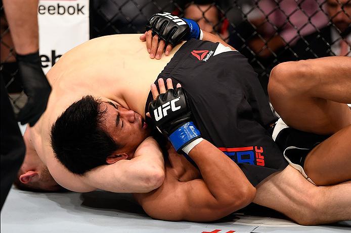 BRISBANE, AUSTRALIA - MARCH 20: Dan Hooker (top) of New Zealand submits Mark Eddiva of the Philippines by guillotine choke in their featherweight bout during the UFC Fight Night event at the Brisbane Entertainment Centre on March 20, 2016 in Brisbane, Au
