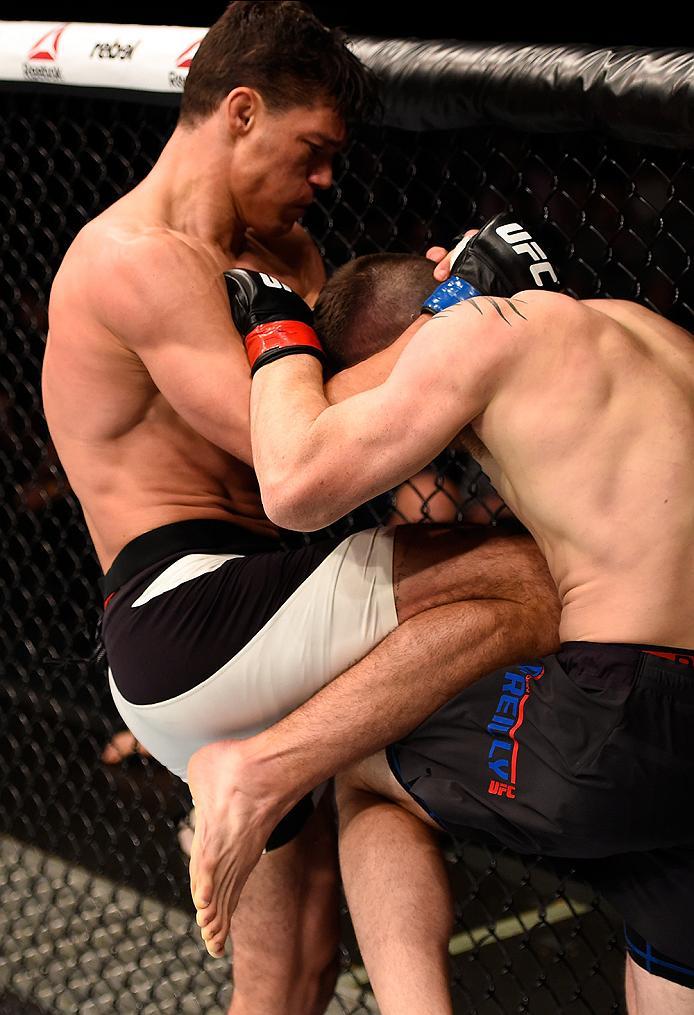 BRISBANE, AUSTRALIA - MARCH 20:  (L-R) Alan Jouban of the United States lands a knee to the body of Brendan O'Reilly of Australia in their welterweight bout during the UFC Fight Night event at the Brisbane Entertainment Centre on March 20, 2016 in Brisban