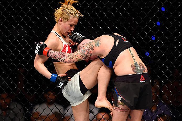 BRISBANE, AUSTRALIA - MARCH 20:  (L-R) Seohee Ham of South Korea lands a knee to the body of Bec Rawlings of Australia in their women's strawweight bout during the UFC Fight Night event at the Brisbane Entertainment Centre on March 20, 2016 in Brisbane, A