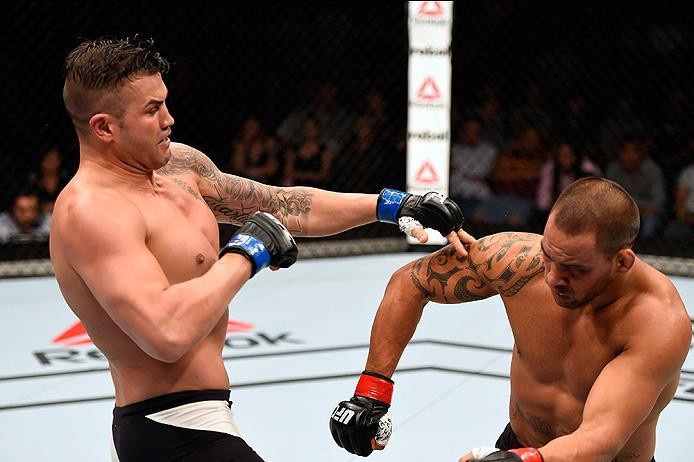 BRISBANE, AUSTRALIA - MARCH 20: (L-R) Steve Bosse of Canada reacts after punching James Te Huna of New Zealand in their light heavyweight bout during the UFC Fight Night event at the Brisbane Entertainment Centre on March 20, 2016 in Brisbane, Australia.