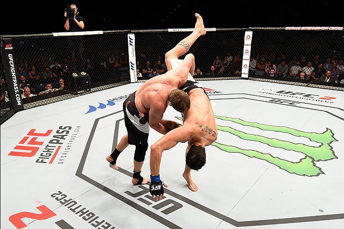 BRISBANE, AUSTRALIA - MARCH 20:  (L-R) Daniel Kelly of Australia takes down Antonio Carlos Junior of Brazil in their middleweight bout during the UFC Fight Night event at the Brisbane Entertainment Centre on March 20, 2016 in Brisbane, Australia. (Photo b