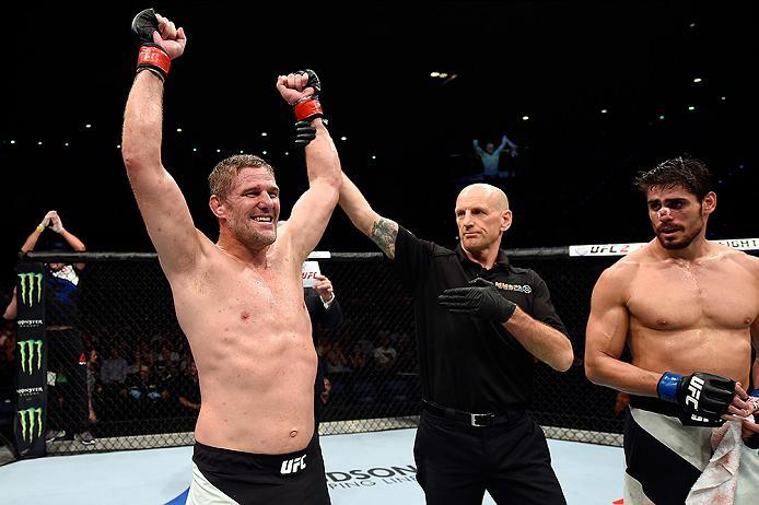 BRISBANE, AUSTRALIA - MARCH 20:  (L-R) Daniel Kelly of Australia celebrates after defeating Antonio Carlos Junior of Brazil by TKO in their middleweight bout during the UFC Fight Night event at the Brisbane Entertainment Centre on March 20, 2016 in Brisba