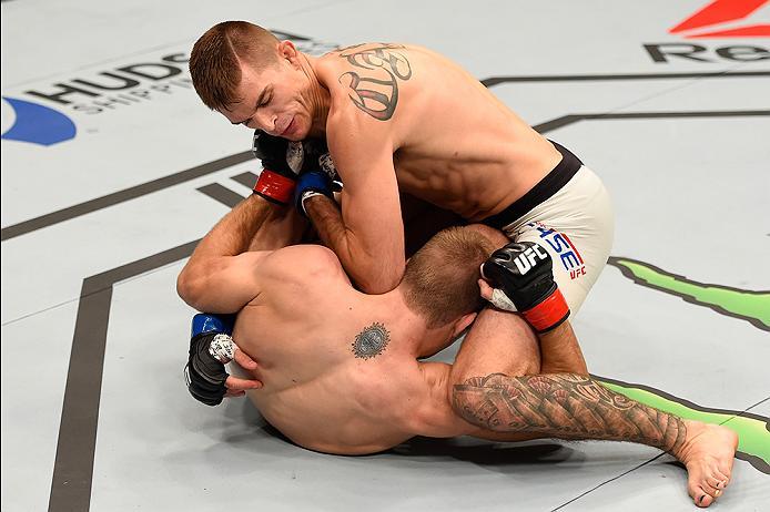 BRISBANE, AUSTRALIA - MARCH 20:  (R-L) Johnny Case controls the body of Jake Matthews of Australia in their lightweight bout during the UFC Fight Night event at the Brisbane Entertainment Centre on March 20, 2016 in Brisbane, Australia. (Photo by Josh Hed