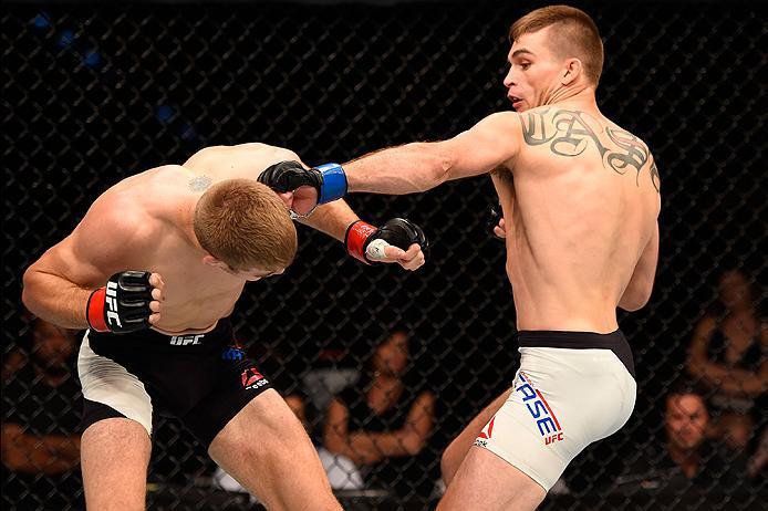 BRISBANE, AUSTRALIA - MARCH 20: (R-L) Johnny Case of the United States punches Jake Matthews of Australia in their lightweight bout during the UFC Fight Night event at the Brisbane Entertainment Centre on March 20, 2016 in Brisbane, Australia. (Photo by