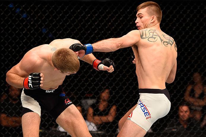 BRISBANE, AUSTRALIA - MARCH 20:  (R-L) Johnny Case of the United States punches Jake Matthews of Australia in their lightweight bout during the UFC Fight Night event at the Brisbane Entertainment Centre on March 20, 2016 in Brisbane, Australia. (Photo by 