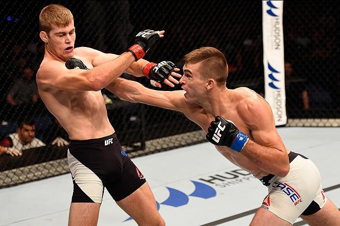 BRISBANE, AUSTRALIA - MARCH 20: (L-R) Johnny Case of the United States punches Jake Matthews of Australia in their lightweight bout during the UFC Fight Night event at the Brisbane Entertainment Centre on March 20, 2016 in Brisbane, Australia. (Photo by