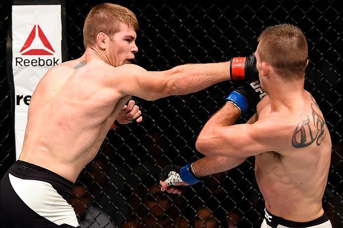 BRISBANE, AUSTRALIA - MARCH 20:  (L-R) Jake Matthews of Australia punches Johnny Case of the United States in their lightweight bout during the UFC Fight Night event at the Brisbane Entertainment Centre on March 20, 2016 in Brisbane, Australia. (Photo by 