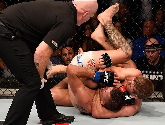 BRISBANE, AUSTRALIA - MARCH 20: (R-L) Jake Matthews of Australia submits Johnny Case of the United States in their lightweight bout during the UFC Fight Night event at the Brisbane Entertainment Centre on March 20, 2016 in Brisbane, Australia. (Photo by