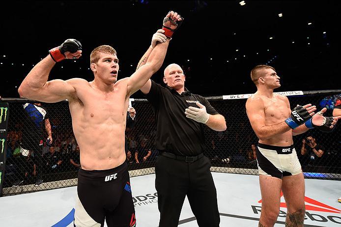 BRISBANE, AUSTRALIA - MARCH 20:  (L-R) Jake Matthews of Australia celebrates after defeating Johnny Case of the United States by submission after their lightweight bout during the UFC Fight Night event at the Brisbane Entertainment Centre on March 20, 201