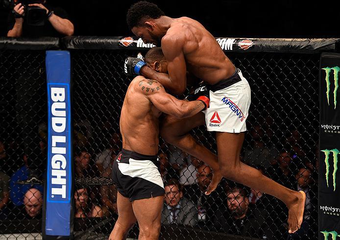 BRISBANE, AUSTRALIA - MARCH 20:  (R-L) Neil Magny of the United States lands a flying knee to the body of Hector Lombard of Cuba in their welterweight bout during the UFC Fight Night event at the Brisbane Entertainment Centre on March 20, 2016 in Brisbane