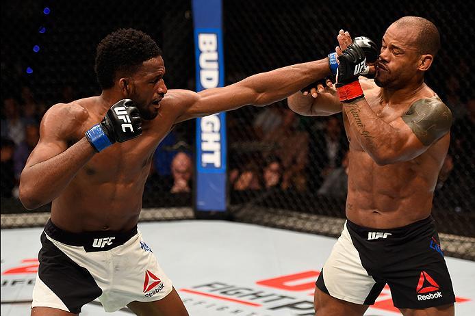 BRISBANE, AUSTRALIA - MARCH 20:  (L-R) Neil Magny of the United States punches Hector Lombard of Cuba in their welterweight bout during the UFC Fight Night event at the Brisbane Entertainment Centre on March 20, 2016 in Brisbane, Australia. (Photo by Josh