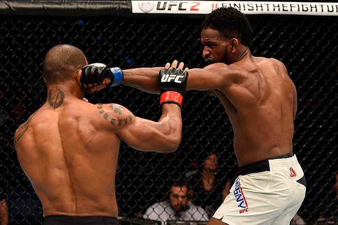 BRISBANE, AUSTRALIA - MARCH 20:  (R-L) Neil Magny of the United States punches Hector Lombard of Cuba in their welterweight bout during the UFC Fight Night event at the Brisbane Entertainment Centre on March 20, 2016 in Brisbane, Australia. (Photo by Josh