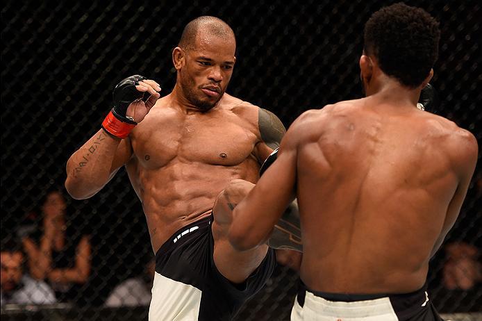 BRISBANE, AUSTRALIA - MARCH 20: (L-R) Hector Lombard of Cuba kicks Neil Magny of the United States in their welterweight bout during the UFC Fight Night event at the Brisbane Entertainment Centre on March 20, 2016 in Brisbane, Australia. (Photo by Josh H