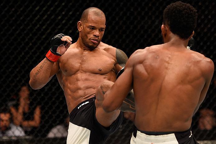 BRISBANE, AUSTRALIA - MARCH 20:  (L-R) Hector Lombard of Cuba kicks Neil Magny of the United States in their welterweight bout during the UFC Fight Night event at the Brisbane Entertainment Centre on March 20, 2016 in Brisbane, Australia. (Photo by Josh H