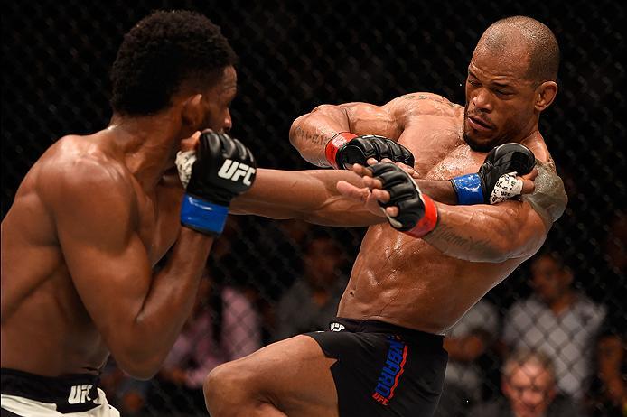 BRISBANE, AUSTRALIA - MARCH 20:  (L-R) Neil Magny of the United States punches Hector Lombard of Cuba in their welterweight bout during the UFC Fight Night event at the Brisbane Entertainment Centre on March 20, 2016 in Brisbane, Australia. (Photo by Josh