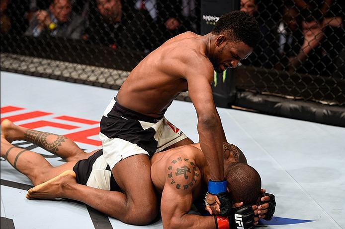 BRISBANE, AUSTRALIA - MARCH 20: (L-R) Neil Magny of the United States controls the body while punching Hector Lombard of Cuba in their welterweight bout during the UFC Fight Night event at the Brisbane Entertainment Centre on March 20, 2016 in Brisbane,