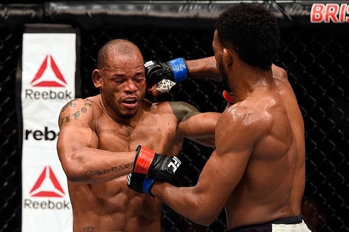 BRISBANE, AUSTRALIA - MARCH 20:  (R-L) Neil Magny of the United States punches Hector Lombard of Cuba in their welterweight bout during the UFC Fight Night event at the Brisbane Entertainment Centre on March 20, 2016 in Brisbane, Australia. (Photo by Josh