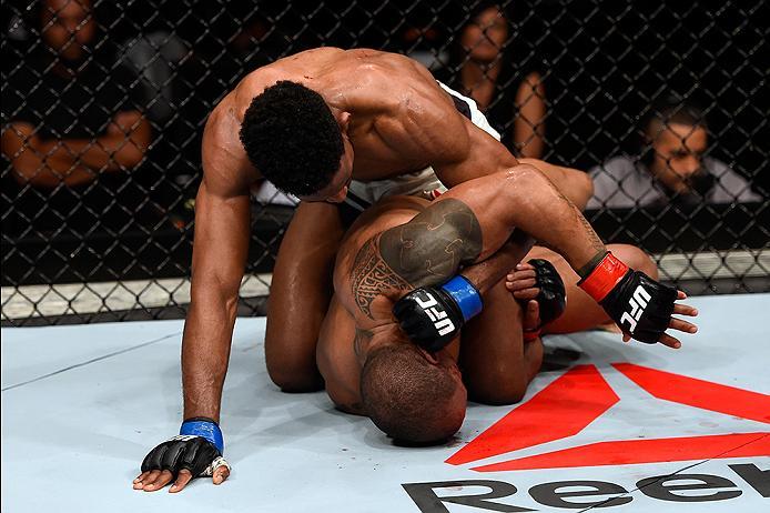 BRISBANE, AUSTRALIA - MARCH 20: (L-R) Neil Magny of the United States controls the body while punching Hector Lombard of Cuba in their welterweight bout during the UFC Fight Night event at the Brisbane Entertainment Centre on March 20, 2016 in Brisbane,