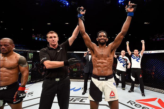 BRISBANE, AUSTRALIA - MARCH 20: (R-L) Neil Magny of the United States celebrates after defeating Hector Lombard of Cuba by TKO in their welterweight bout during the UFC Fight Night event at the Brisbane Entertainment Centre on March 20, 2016 in Brisbane,