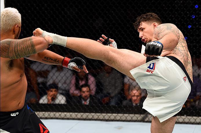 BRISBANE, AUSTRALIA - MARCH 20: (R-L) Frank Mir of the United States kicks Mark Hunt of New Zealand in their heavyweight bout during the UFC Fight Night event at the Brisbane Entertainment Centre on March 20, 2016 in Brisbane, Australia. (Photo by Josh H