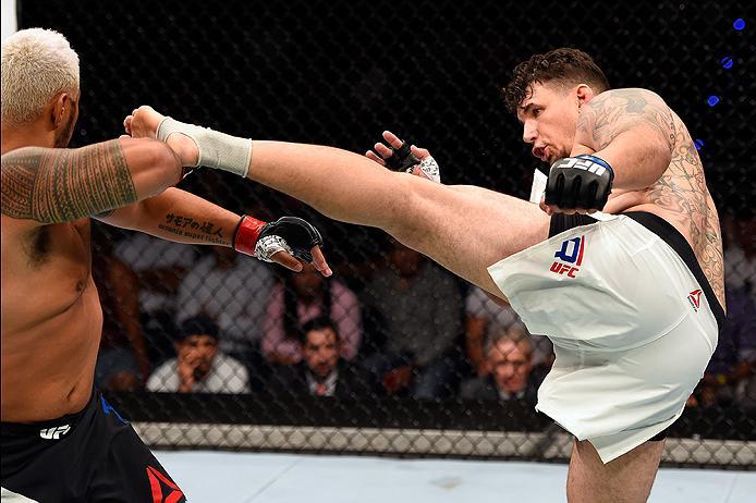 BRISBANE, AUSTRALIA - MARCH 20:  (R-L) Frank Mir of the United States kicks Mark Hunt of New Zealand in their heavyweight bout during the UFC Fight Night event at the Brisbane Entertainment Centre on March 20, 2016 in Brisbane, Australia. (Photo by Josh H