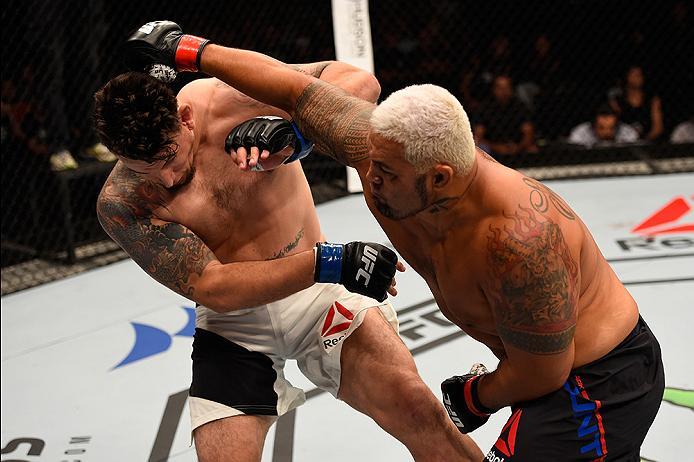 BRISBANE, AUSTRALIA - MARCH 20: (R-L) Mark Hunt of New Zealand punches Frank Mir of the United States in their heavyweight bout during the UFC Fight Night event at the Brisbane Entertainment Centre on March 20, 2016 in Brisbane, Australia. (Photo by Josh
