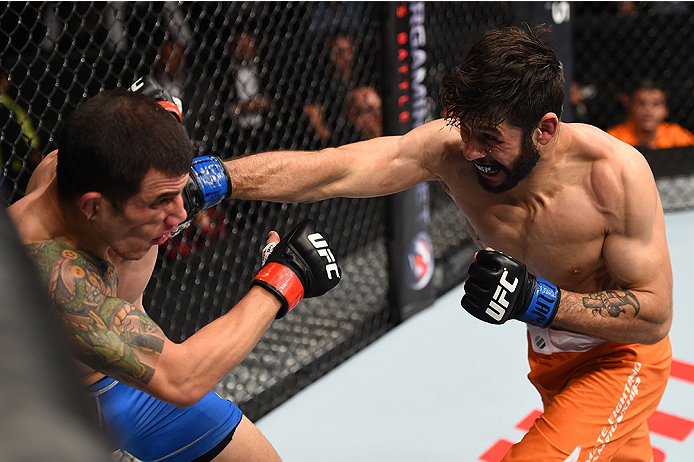 MONTERREY, MEXICO - NOVEMBER 21: (R-L) Polo Reyes of Mexico punches Cesar Arzamendia of Paraguay in their lightweight bout during the UFC Fight Night event at Arena Monterrey on November 21, 2015 in Monterrey, Mexico. (Photo by Jeff Bottari/Zuffa LLC/Zu